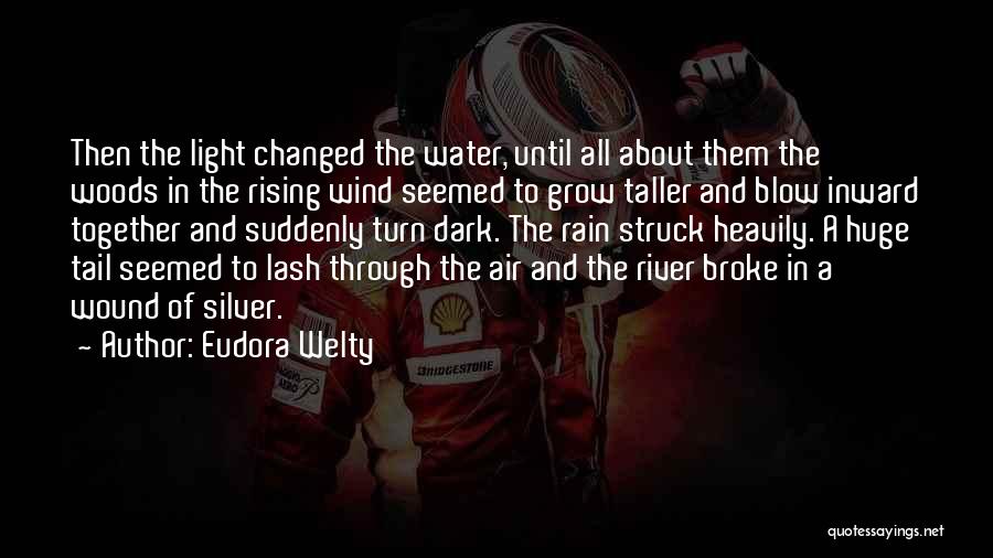 Eudora Welty Quotes: Then The Light Changed The Water, Until All About Them The Woods In The Rising Wind Seemed To Grow Taller