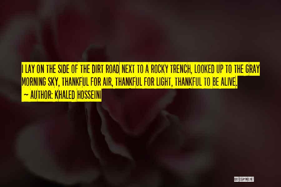 Khaled Hosseini Quotes: I Lay On The Side Of The Dirt Road Next To A Rocky Trench, Looked Up To The Gray Morning